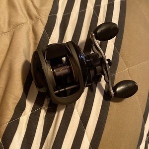 Bait caster reel, black and gold, never used